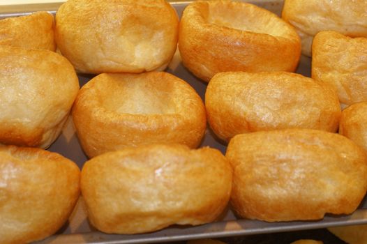 hot individuel yorkshire puddings in a baking tin