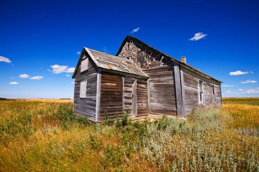 Old wooden church abandoned in a prairie field