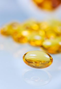 vitamin pill close-up on a reflective table