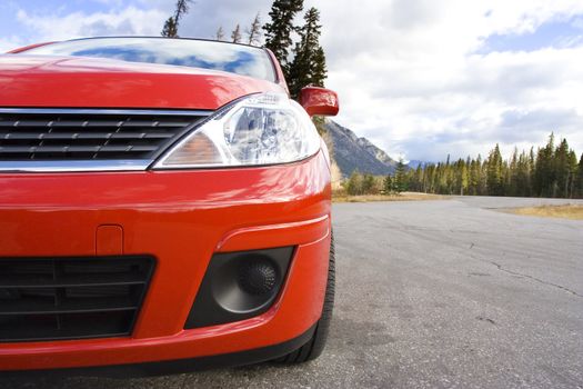 Red family car parked in a mountain rest area