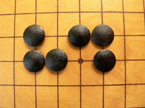 Black stones on the go-board.