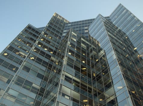 A very tall glass faced office building 