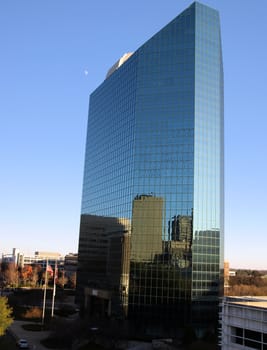 Glass office building reflecting nearby buildings