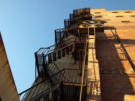 Up the back fire escape of an old building