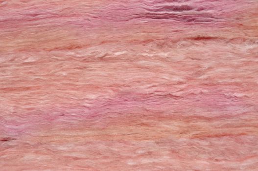 Home construction: Close-up of pink fiberglass insulation material.