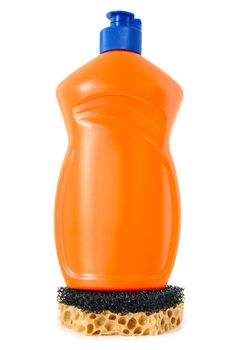 Detergent in orange plastic bottle and sponge on isolated background