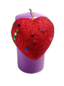 Violet candle with a red heart with a filigree attached to the Valentine's Day