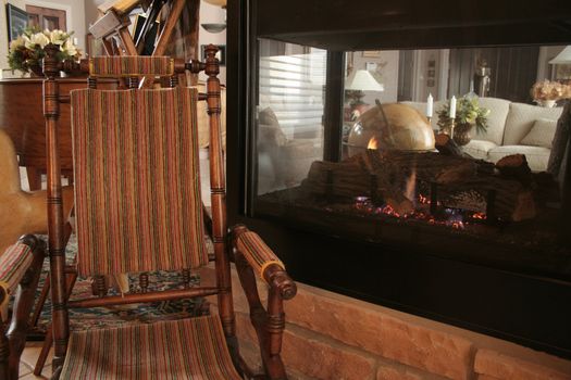 cozy rocking chair next to fireplace