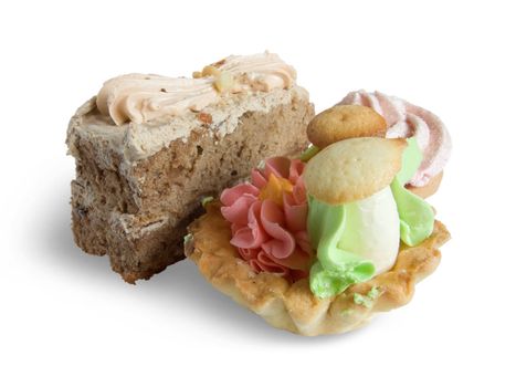 Biscuit cakes with an oil cream on white. Isolated