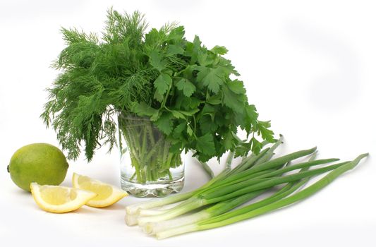 nice fresh greens, leek, lemon and lime isolated over white                