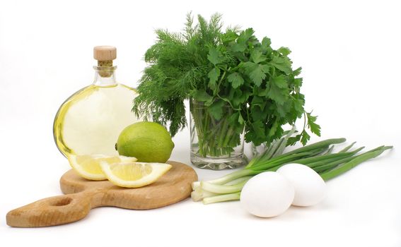 nice fresh herbs, leek, lemon, lime, oil and eggs isolated over white             