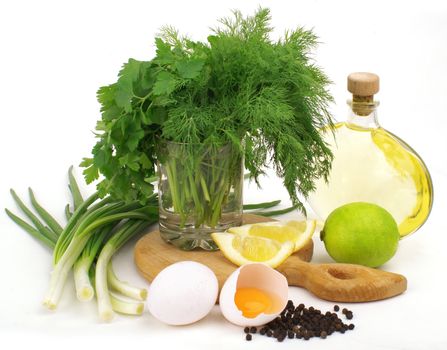 nice fresh herbs, leek, lemon, lime, oil and eggs isolated on white background          