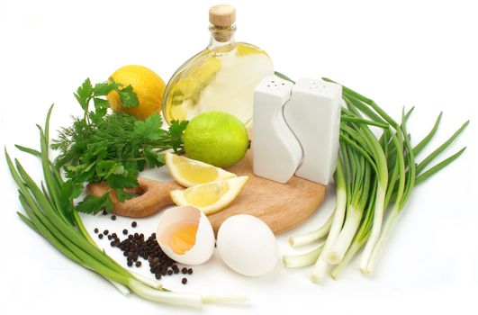 fresh herbs, leek, lemon, lime, oil, spices and eggs isolated on white background             