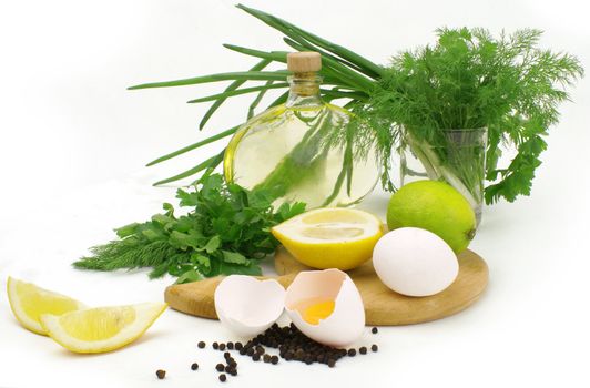 fresh herbs, leek, lemon, lime, spices, oil and eggs isolated on white background             