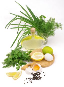 fresh herbs, leek, lemon, lime, spices, oil and eggs isolated on white background                        