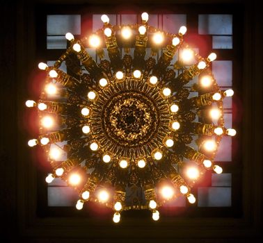 Looking up at a large ornate gold chandelier in Grand Central Station