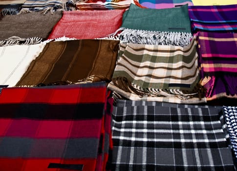 Row of winter scarves on a table at a market