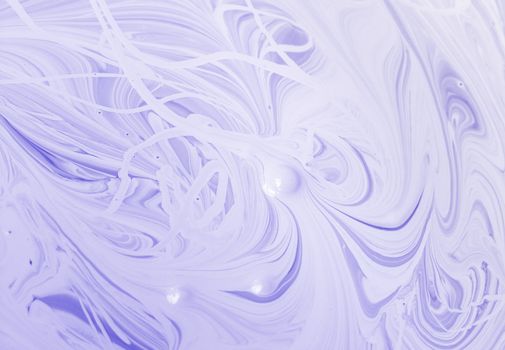 Can of paint that has separated into swirls of white and lavender