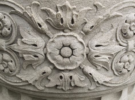 Ornate floral design carved into old stone wall