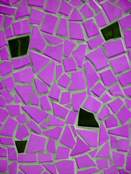 Brignt pink and black mosaic in concrete
