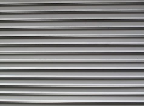 Gray steel garage door with horzontal lines