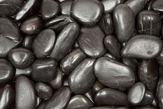 Tiny black stones forming a dark background.