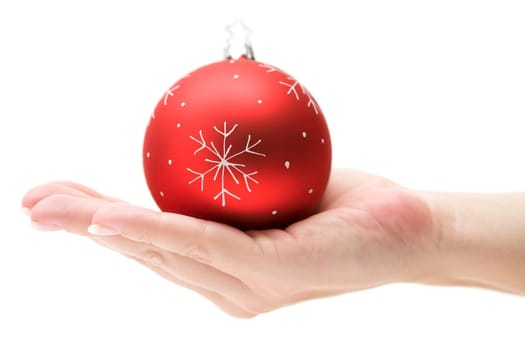 Female hand presenting a red Christmas tree ball. Isolated on a white background.