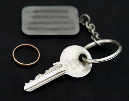 Key with trinket on a black background