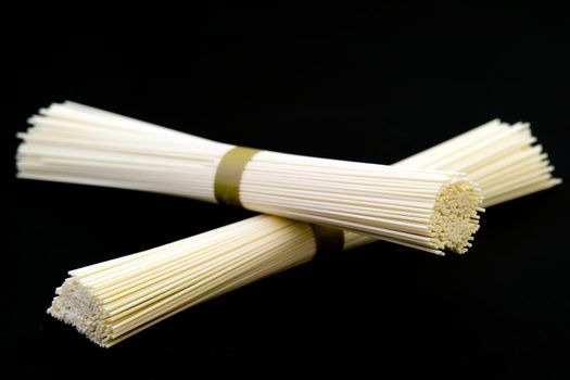 Japanese white wheat noodles on a black background