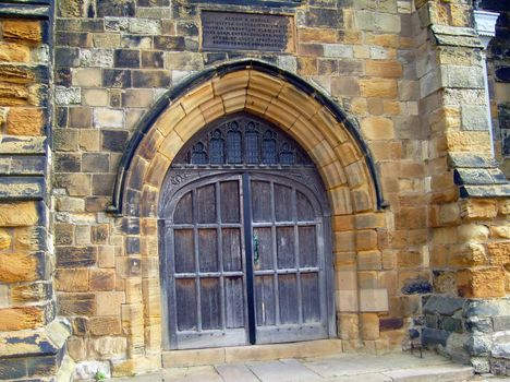Exterior of church doors in gothic style building.