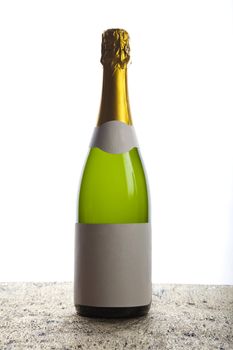 Beautiful big green bottle of chilled champagne on a delicate background