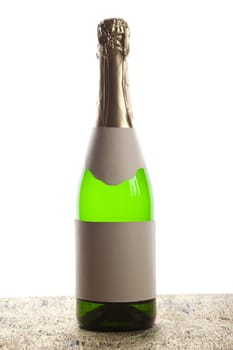 Beautiful big green bottle of chilled champagne on a delicate background