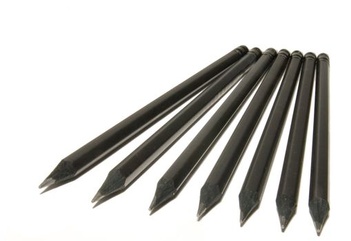 Many black pencils on a white background