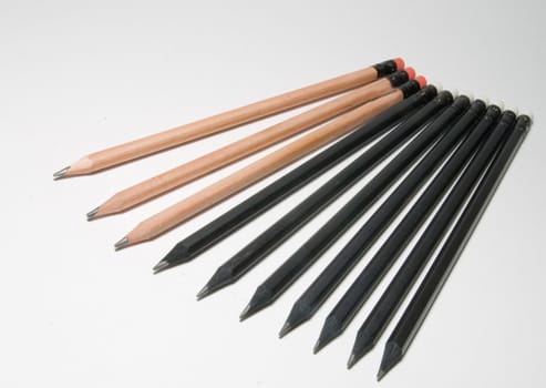 Many black pencils on a white background