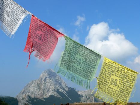 four tibetan flags and mountain