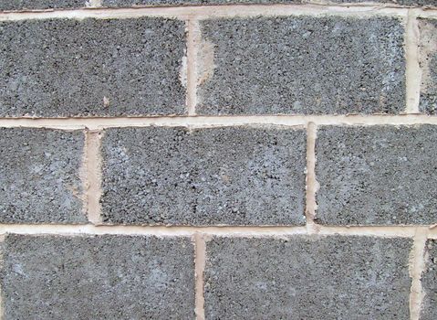 Breeze blocks cemented in wall for building foundations.