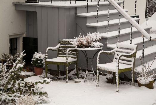 garden seats covered with snow