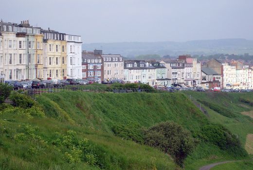 Tourist bed and breakfast hotels on edge of cliff in resort of Scarborough, England.