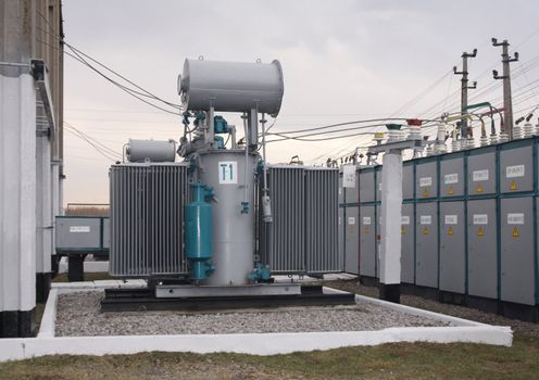 Power transformer in a distribution substation separated from another one by a wall
