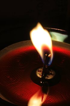 Red candle in dark room