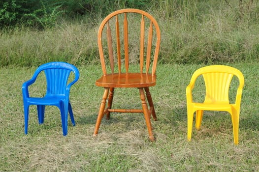 mother, son, and daughter chairs on the lawn outdoors.