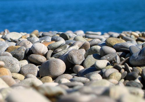 Sea Pebbles in front of Sea in Sunny Day