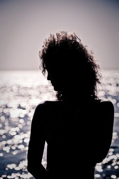 Silhouette of young woman in the water