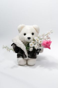 Teddy bear with a bunch of flowers