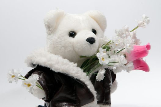 Teddy bear with a bunch of flowers