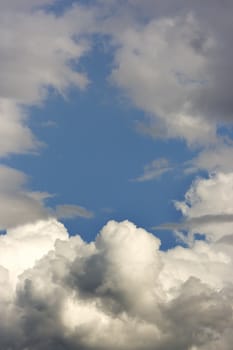 cloud in the blue sky in a gorwing dark storm