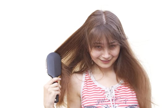 Young girl brushing her long dark hair