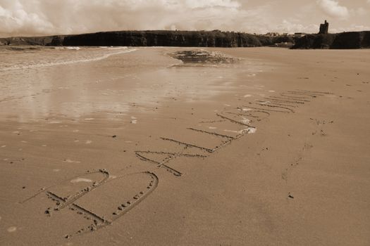 ballybunion inscribed on the beach with ocean waves and a castle in the background
