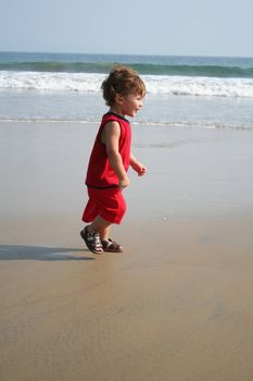 Little boy playing on the beach