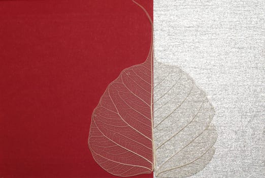 aged leaf over red-silver background